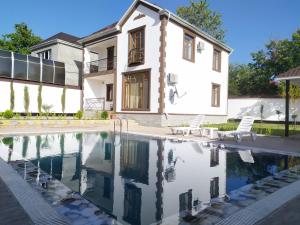 a house with a swimming pool in front of a house at Luxury Milan Gabala hot pool, mountain view, cable car in Gabala