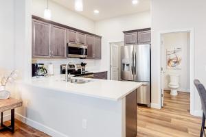 a kitchen with a white counter top and a refrigerator at Placita Escondida #204 in Tucson