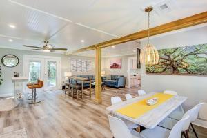 a dining room and living room with a table and chairs at Surf Bungalow in Folly Beach