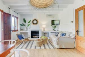 a living room with a couch and a fireplace at Villa Martin by Villa Plus in El Port
