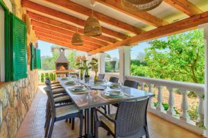 a dining room with a table and chairs and a fireplace at Villa Martin by Villa Plus in El Port