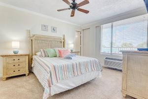 a bedroom with a bed and a ceiling fan at Ocean Jewels Club #312 in Daytona Beach