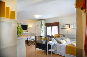 a living room and kitchen with a couch and a table at Casa Rural "Hazanas" Adanero in Adanero