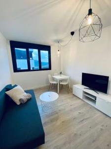 a living room with a couch and a table at Acogedor y cómodo apartamento con piscina in Las Palmas de Gran Canaria