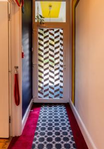 a hallway with a door with a colorful wall at Number 18 in Conwy