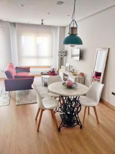 a living room with a table and chairs at Loft Oviedo in Oviedo