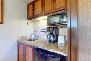 a kitchen with a sink and a counter top at Islander on the Beach 339 in Kapaa