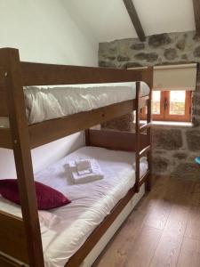 a couple of bunk beds in a room at BezerreiraComVida-O refúgio do monte in Bezerreira +32 photos