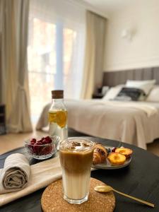 a table topped with a drink and a plate of food at MIA N 37 Apartament Ełk in Ełk