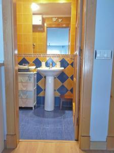 a bathroom with a sink and a mirror at Loft Oviedo in Oviedo