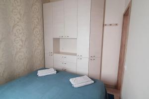a bedroom with a blue bed and white cabinets at Playa San Juan apartment in Playa de San Juan