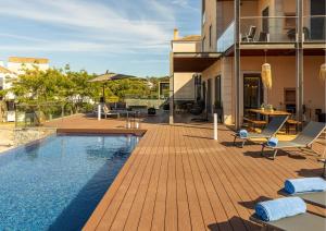 a house with a pool and a deck with chairs at Algarve: Vale Lobo Golf&Beach with Private Pool II in Almancil