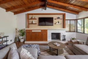 a living room with a couch and a fireplace at Solana Beach House! Minutes to Dog Beach & Cedros in Solana Beach