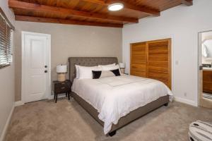 a bedroom with a large bed with a wooden headboard at Solana Beach House! Minutes to Dog Beach & Cedros in Solana Beach