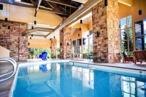 a swimming pool in a building with a brick wall at Cedar Breaks Lodge in Brian Head