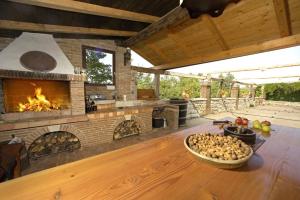 an outdoor kitchen with a fireplace and a bowl of food on a table at Stancija Baladur in Rakovci - 3 Häuschen für insgesamt 6 Personen Baladur 3 in Baderna