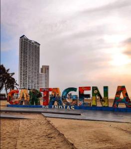 a sign on the beach in front of a city at Cabrero Beach 1111 in Cartagena de Indias