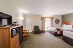 a hotel room with a bed and a television at Best Western Graham's in Murdo +24 photos