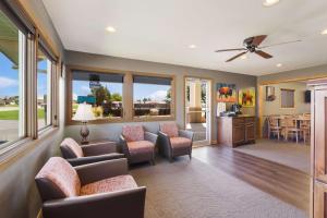 a living room with a couch and chairs and a kitchen at Best Western Graham's in Murdo