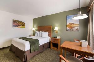 a hotel room with a bed and a desk at Best Western Graham's in Murdo