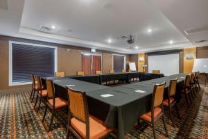 a conference room with a long table and chairs at Best Western Plus Chateau Fort St. John in Fort Saint John