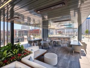 a restaurant with tables and chairs and a view of a city at Level Chicago - River North in Chicago