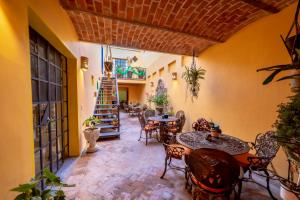 a patio with tables and chairs and a staircase at La Casona Chapala in Chapala