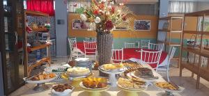 uma mesa com muitos tipos diferentes de alimentos sobre ele em Natalina Pousada & Restaurante em Nova Trento