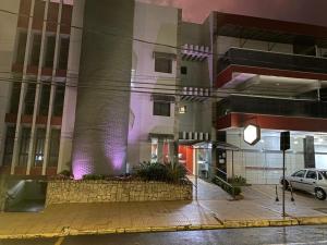 a building with a car parked in front of it at Carlton Plaza Torre in Araxá