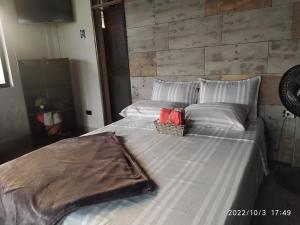 a large bed with a basket on top of it at Villa Juliana in Buenaventura