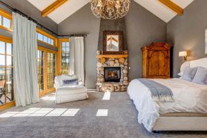 a bedroom with a large bed and a fireplace at Modern Hillside Manor in Park City