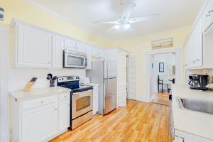 a kitchen with white appliances and a ceiling fan at Fun in the Ocean City Sun in Ocean City