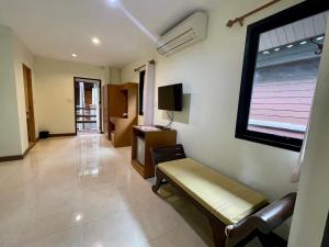 - un salon avec un canapé et une fenêtre dans l'établissement Baantip Suantong, à Amphawa