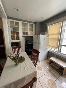 a kitchen with a table and a white refrigerator at Home Away From Home in Wakefield