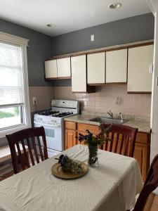 a kitchen with a table with a table cloth on it at Home Away From Home in Wakefield