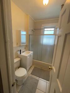 a bathroom with a toilet and a sink and a shower at Home Away From Home in Wakefield