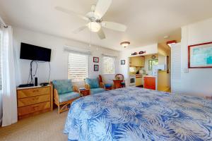 a bedroom with a bed and a ceiling fan at Kapa'a Sands 12 in Kapaa