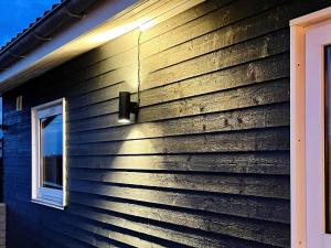 a house with a light on the side of it at 10 person holiday home in Roslev in Flovtrup