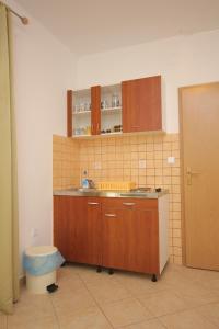 a kitchen with a sink and a counter top at Apartments by the sea Kraj, Pasman - 8247 in Tkon
