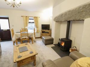 a living room with a couch and a fireplace at Bridgeway House in Blaenau-Ffestiniog