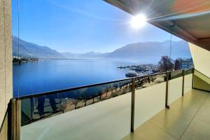 a balcony with a view of a body of water at Residenza Vivian in Locarno