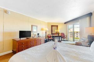 a bedroom with a bed with a dress on it at Kauai Beach Resort #1317 in Lihue