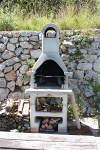 a stone wall with an outdoor oven in front of it at Apartments with WiFi Beli, Cres - 8094 in Beli