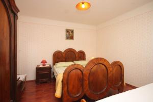 a bedroom with a wooden bed with a wooden headboard at Apartments with WiFi Beli, Cres - 8094 in Beli