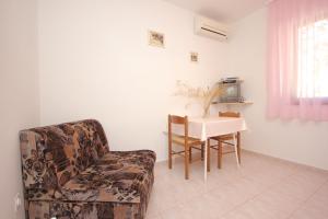 a living room with a chair and a table at Seaside holiday house Cove Rogacic, Vis - 8889 in Vis