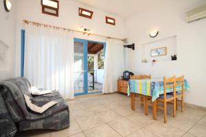 a living room with a table and a couch at Apartments by the sea Milna, Vis - 8943 in Rukavac
