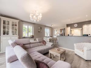 a living room with a couch and a table at Inviting holiday home in Nieuwpoort with private garden in Nieuwpoort