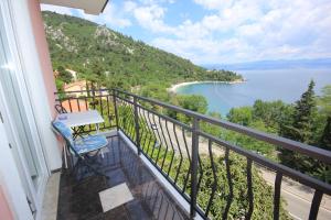 a balcony with a table and a view of the water at Double Room Medveja 2305a in Lovran
