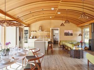 a kitchen and living room with a wooden ceiling at Kowloon Park in Llanymynech