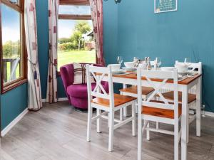 a white table and chairs in a dining room at Lodge Two, Country View Park in Faversham